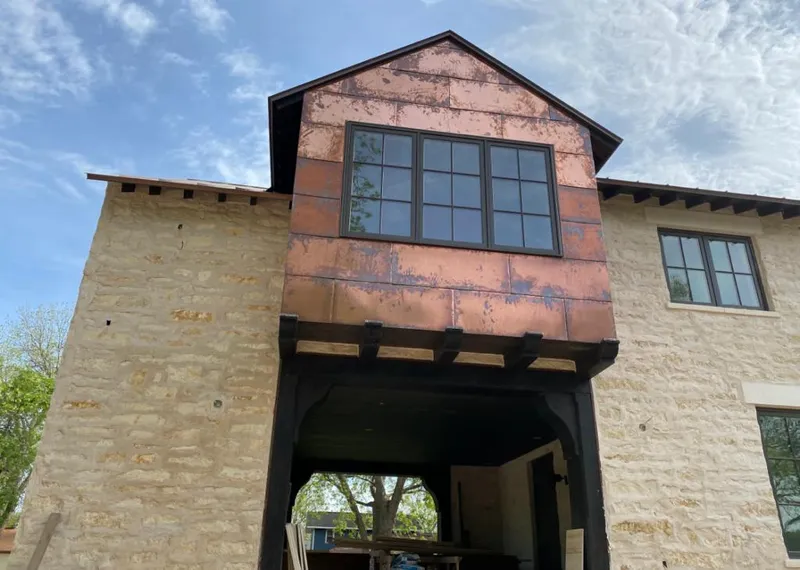 Copper metal panel facade on a stone building for Metal Roof Coating in Walkertown